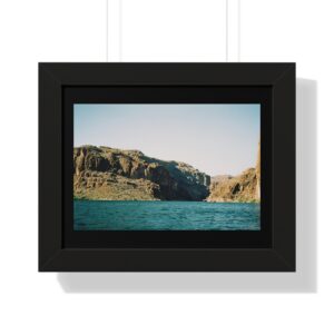 Framed photo of rocky shoreline and water.