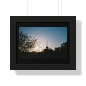 Framed sunset scene with silhouetted cacti.