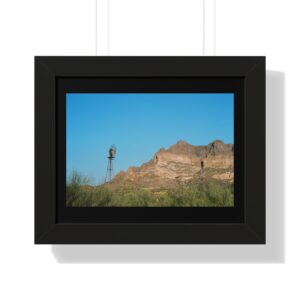 Rustic windmill beside sunlit desert mesa