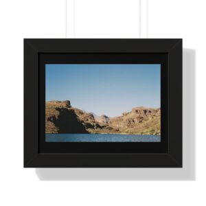 Framed landscape photo with mountains and water.